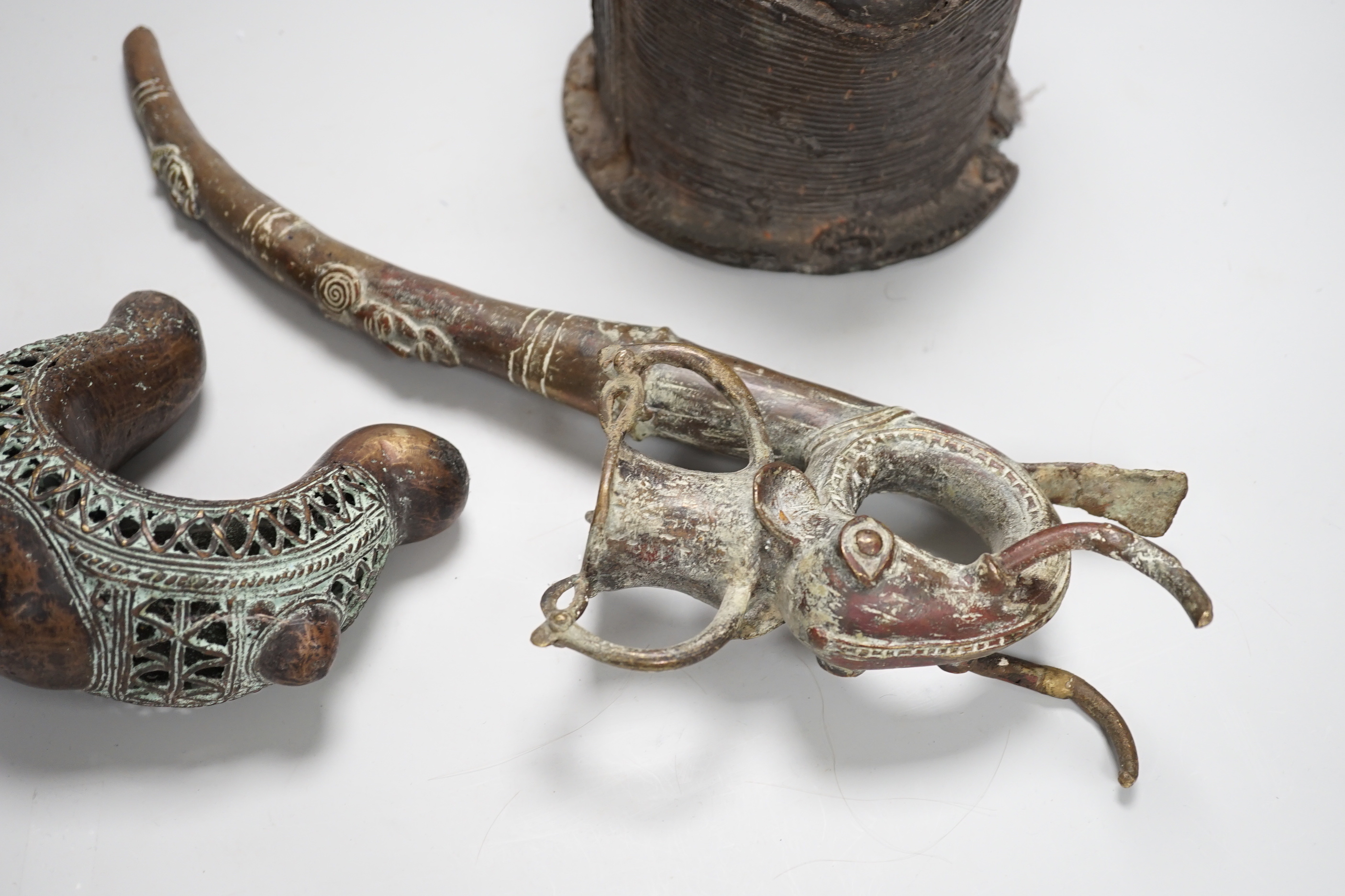 West African bronzes: Benin, a male and a female head, bangle anklet, a ceremonial pipe, ornamental ladle (5)